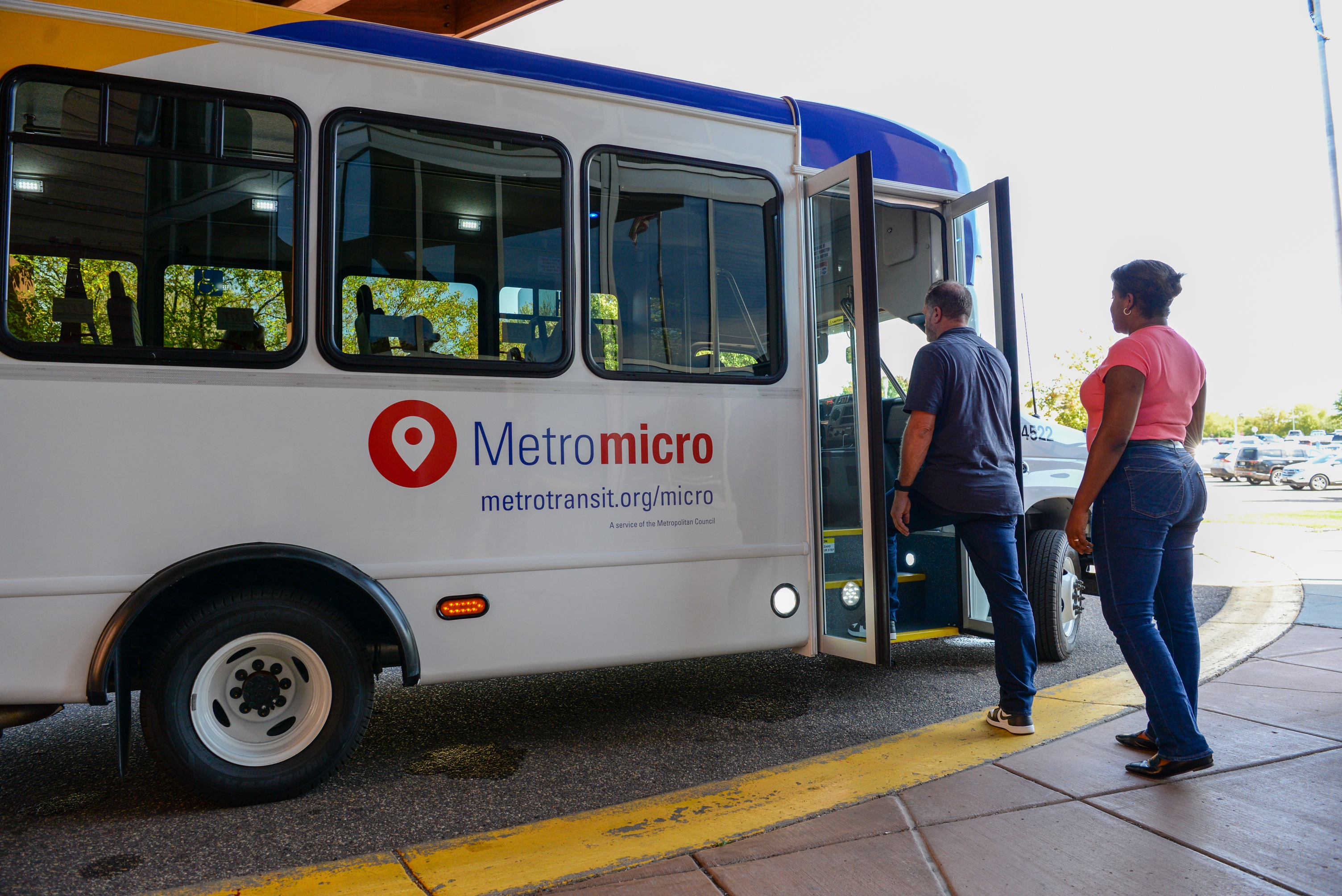 Riders board a Metro micro bus. 