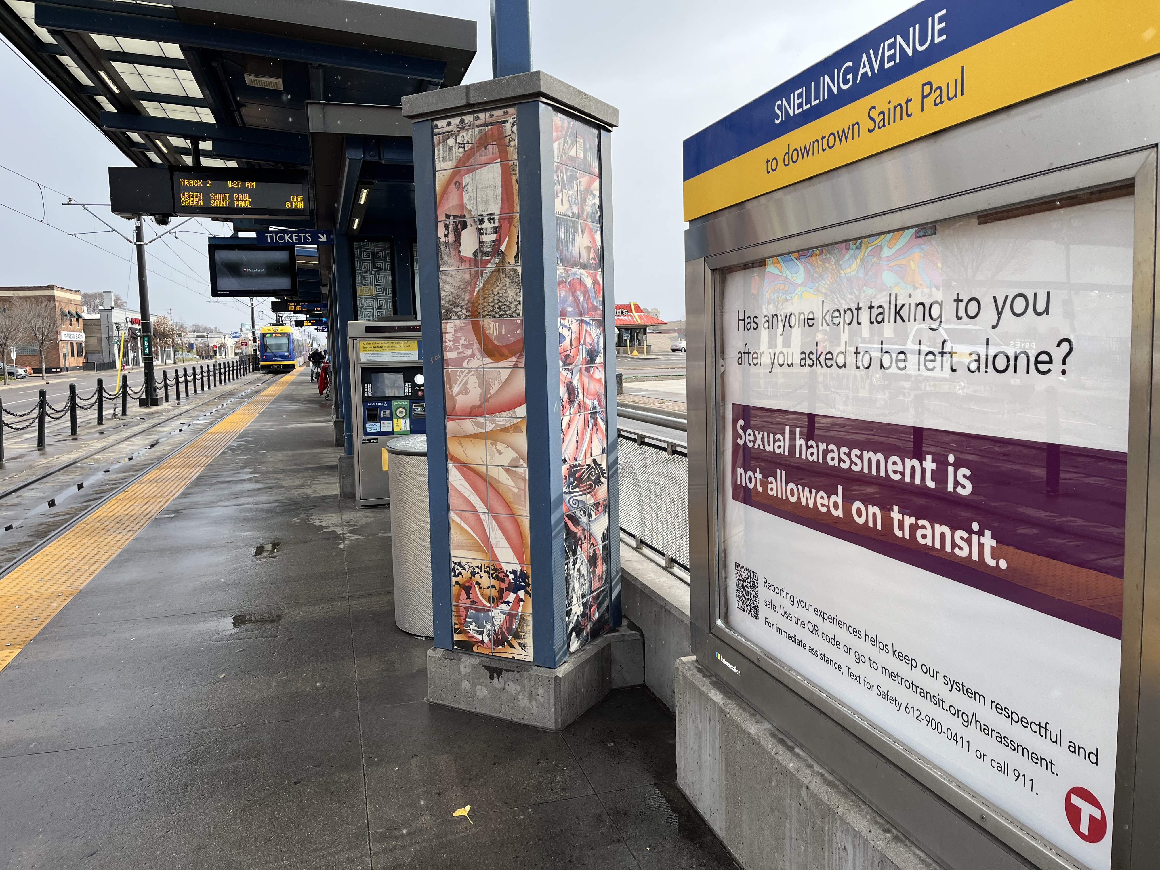 A sign at the Green Line's Snelling Avenue Station that says sexual harassment is not tolerated on transit.