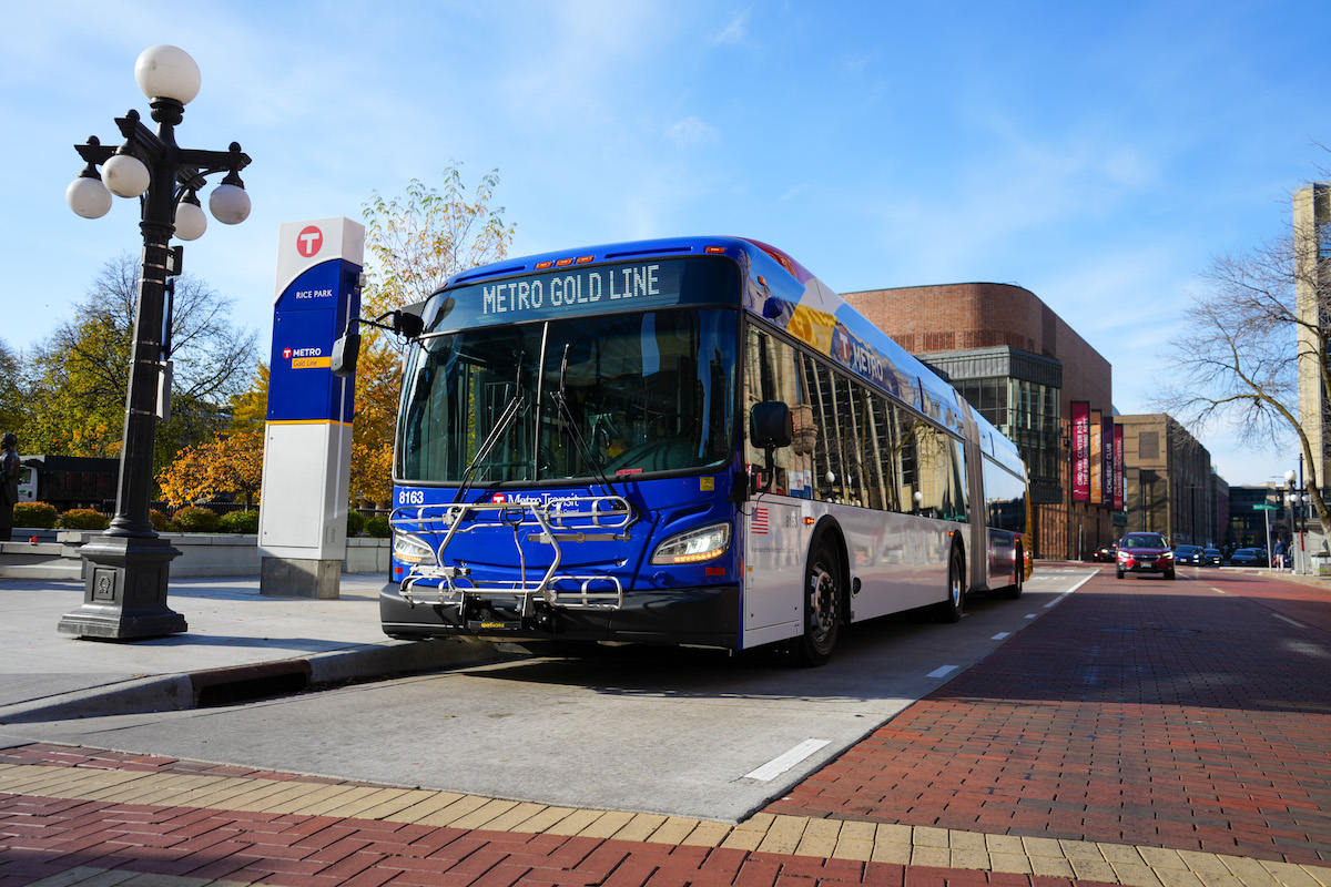 A photo of a Gold Line bus at a stop.