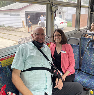 General Manager Lesley Kandaras speaking with a customer on a bus