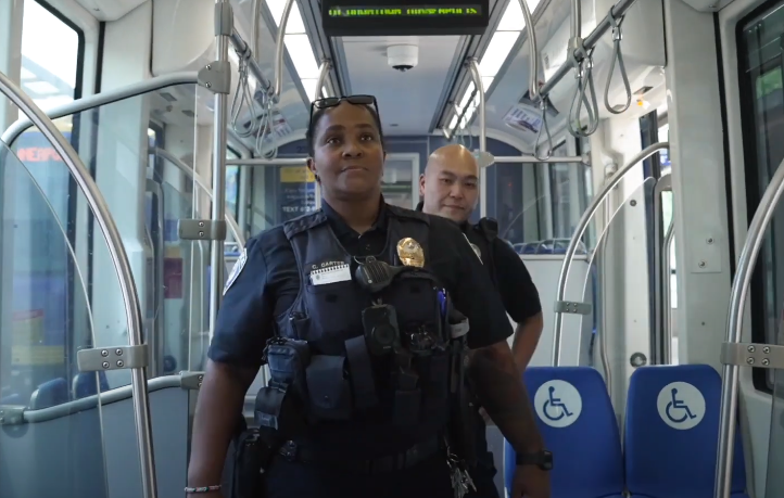 Two Metro Transit Police officers patrol a METRO line train